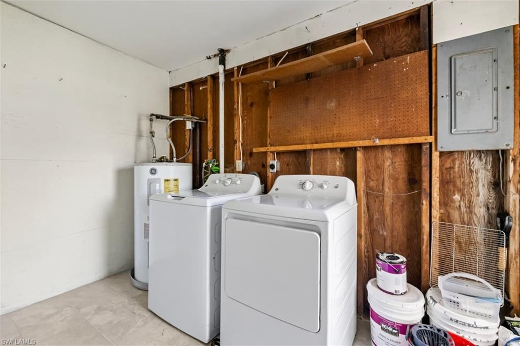 1948 46th Street Southwest Naples, FL 34116 - Photo 29 of 42 Laundry room featuring electric panel, electric water heater, and separate washer and dryer