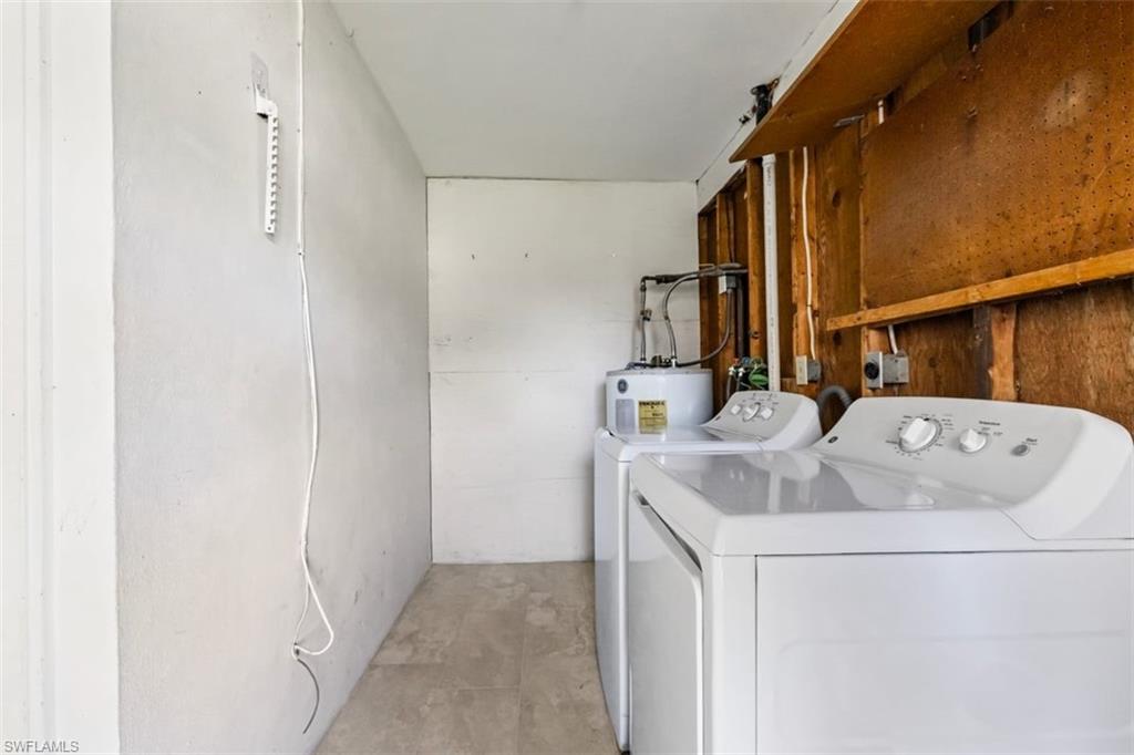 1948 46th Street Southwest Naples, FL 34116 - Photo 30 of 42 Laundry room featuring independent washer and dryer and electric water heater