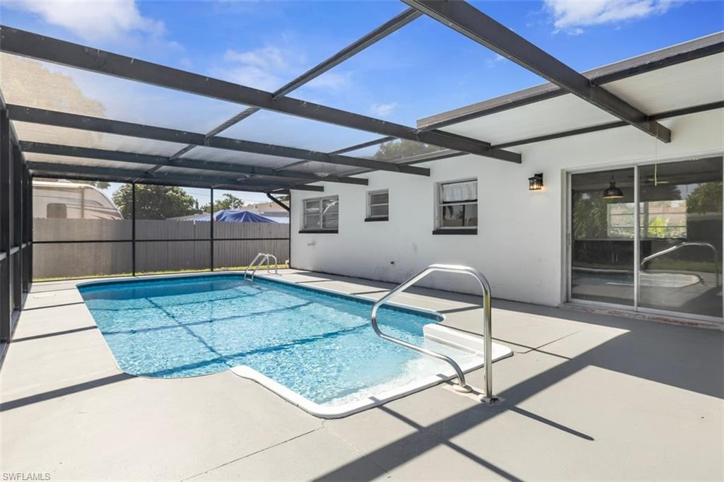 1948 46th Street Southwest Naples, FL 34116 - Photo 32 of 42 View of swimming pool featuring a sunroom, a patio area, and a lanai