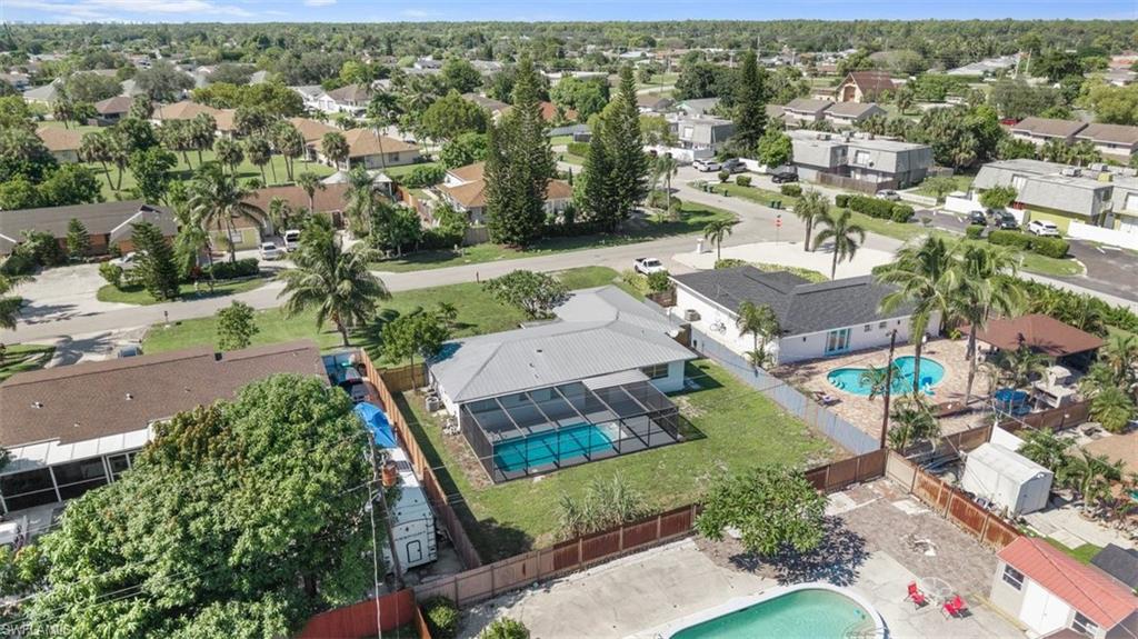 1948 46th Street Southwest Naples, FL 34116 - Photo 37 of 42 Aerial view of residential area featuring a pool area