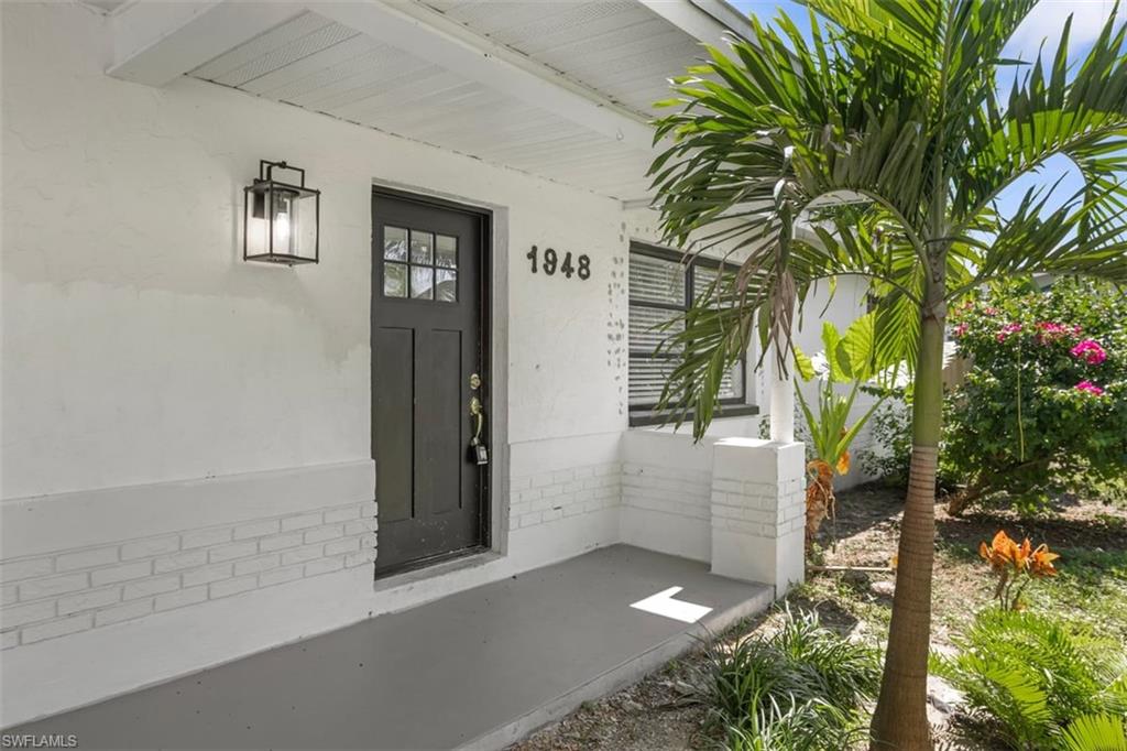 1948 46th Street Southwest Naples, FL 34116 - Photo 5 of 42 Entrance to property with a porch and stucco siding