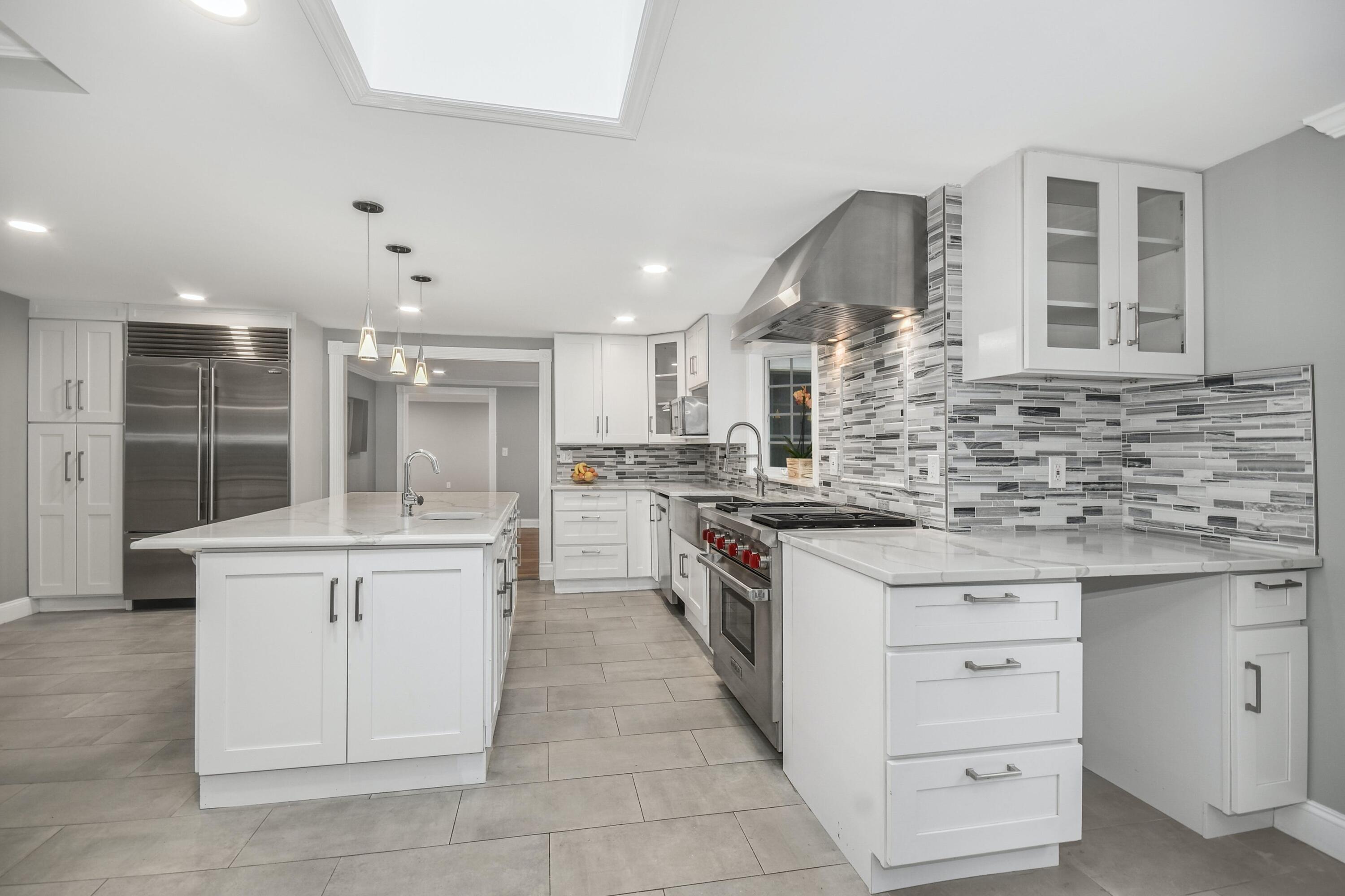 87 Juniper Road New Canaan, CT 06840 - Photo 11 of 28 a kitchen with a sink stove and cabinets
