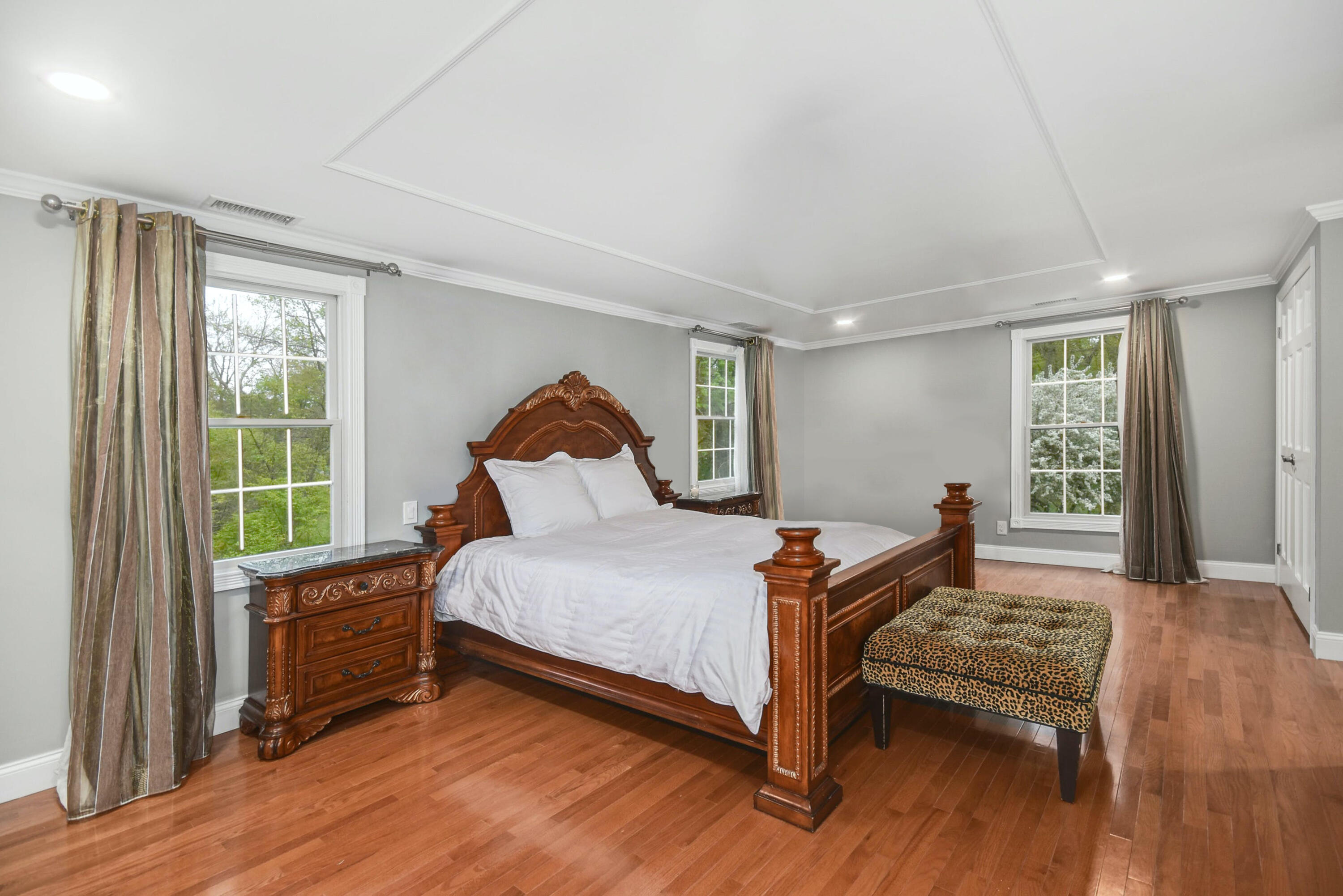 87 Juniper Road New Canaan, CT 06840 - Photo 15 of 28 a bedroom with a bed and wooden floor