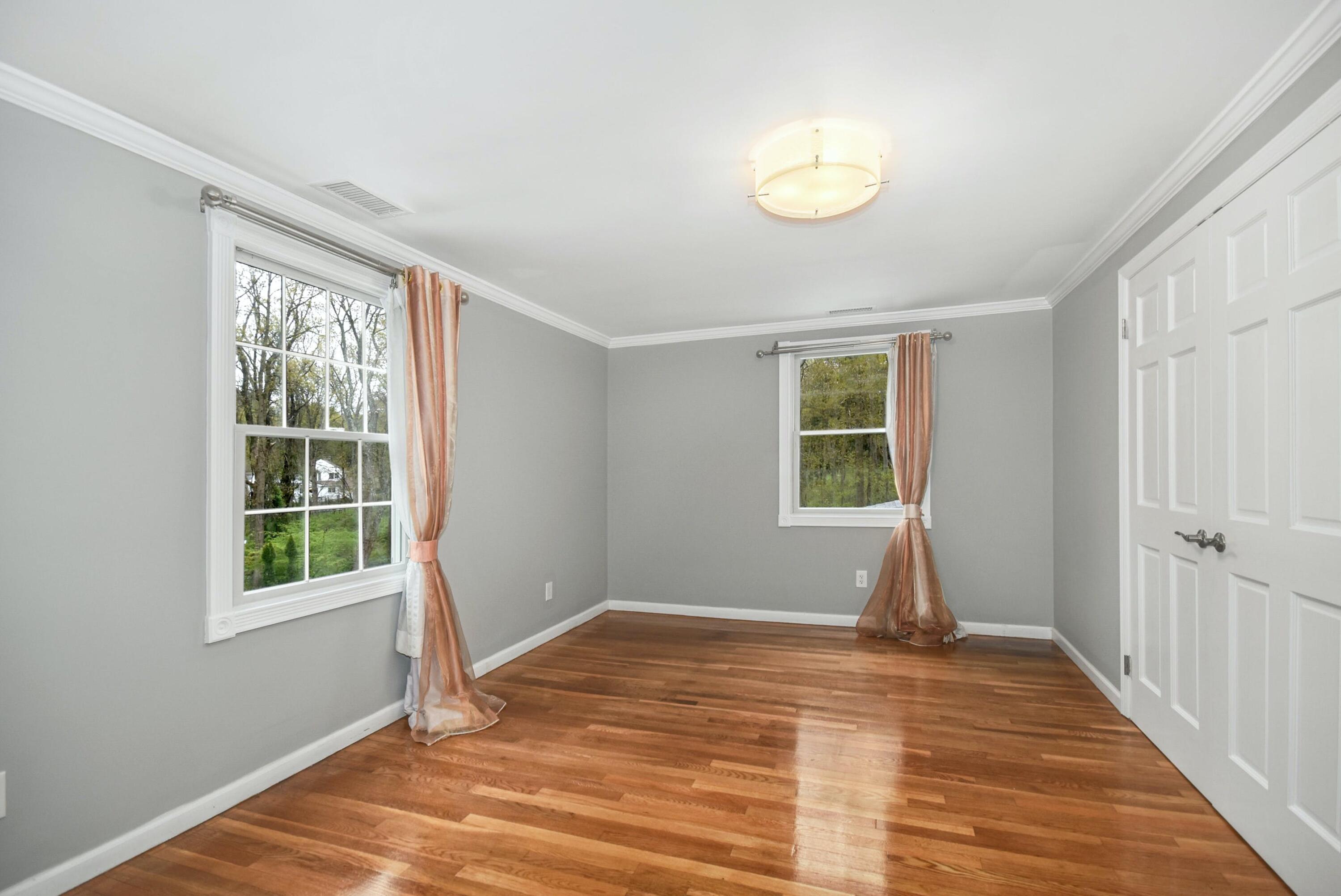 87 Juniper Road New Canaan, CT 06840 - Photo 18 of 28 a view of a room with wooden floor and windows