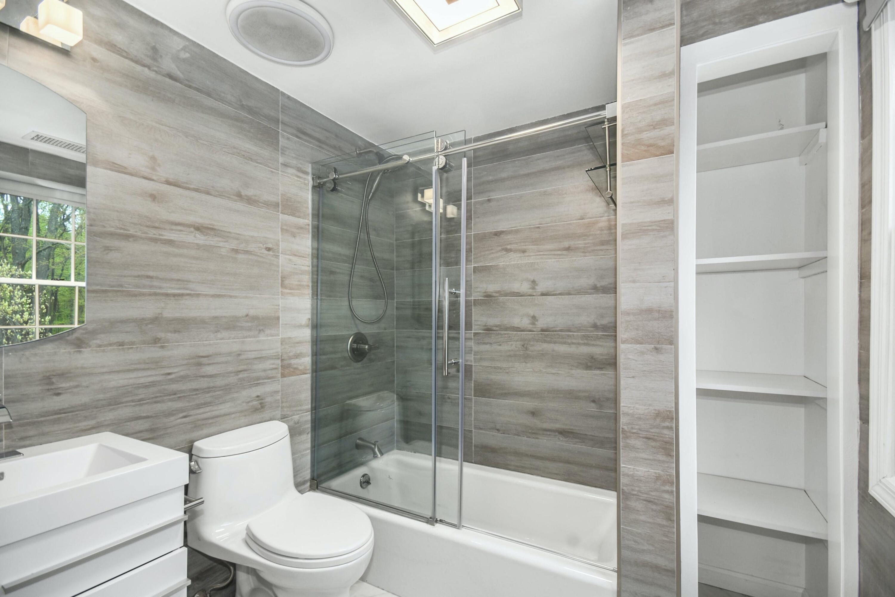 87 Juniper Road New Canaan, CT 06840 - Photo 19 of 28 a bathroom with a shower and a toilet