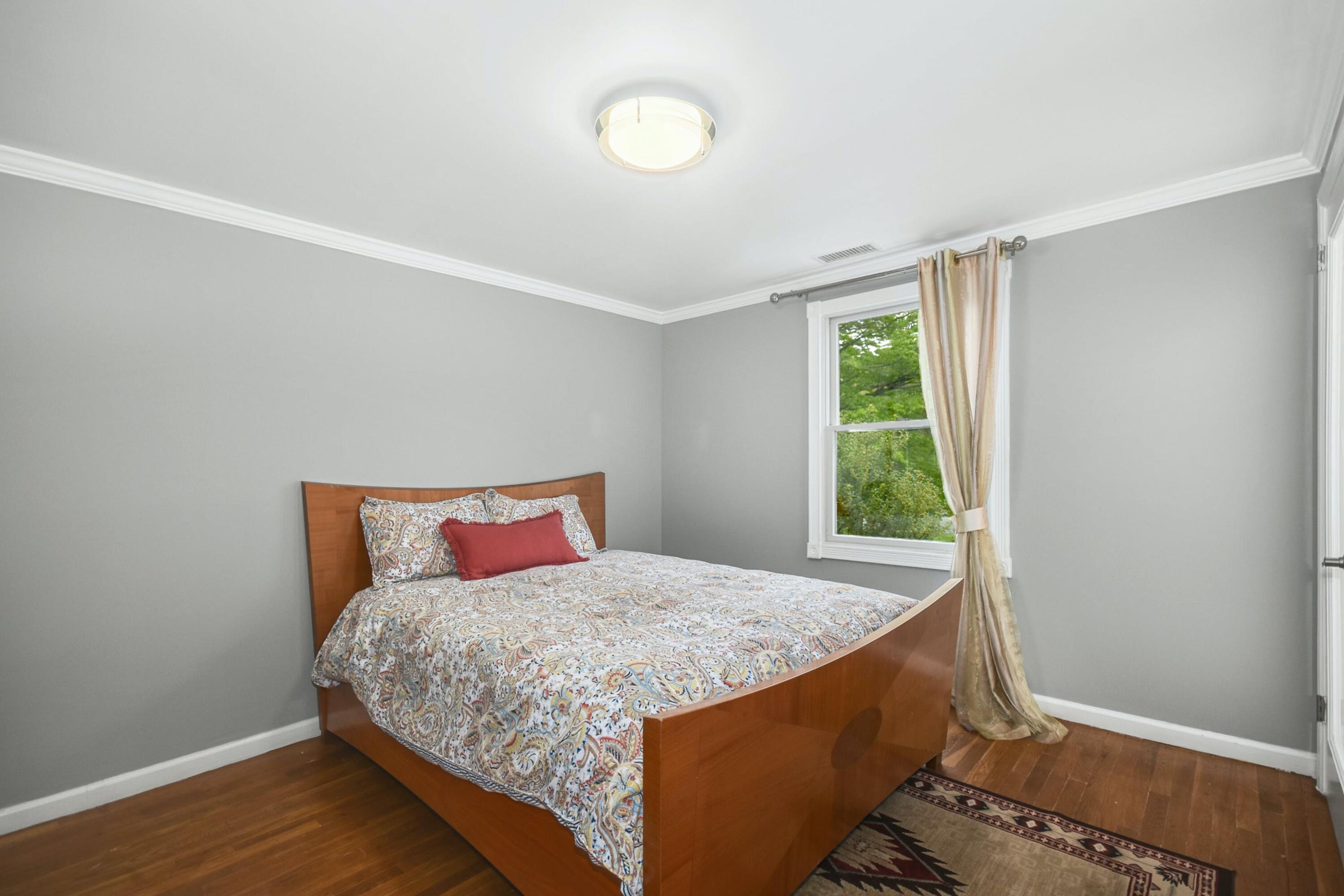 87 Juniper Road New Canaan, CT 06840 - Photo 20 of 28 a bedroom with a bed and a window