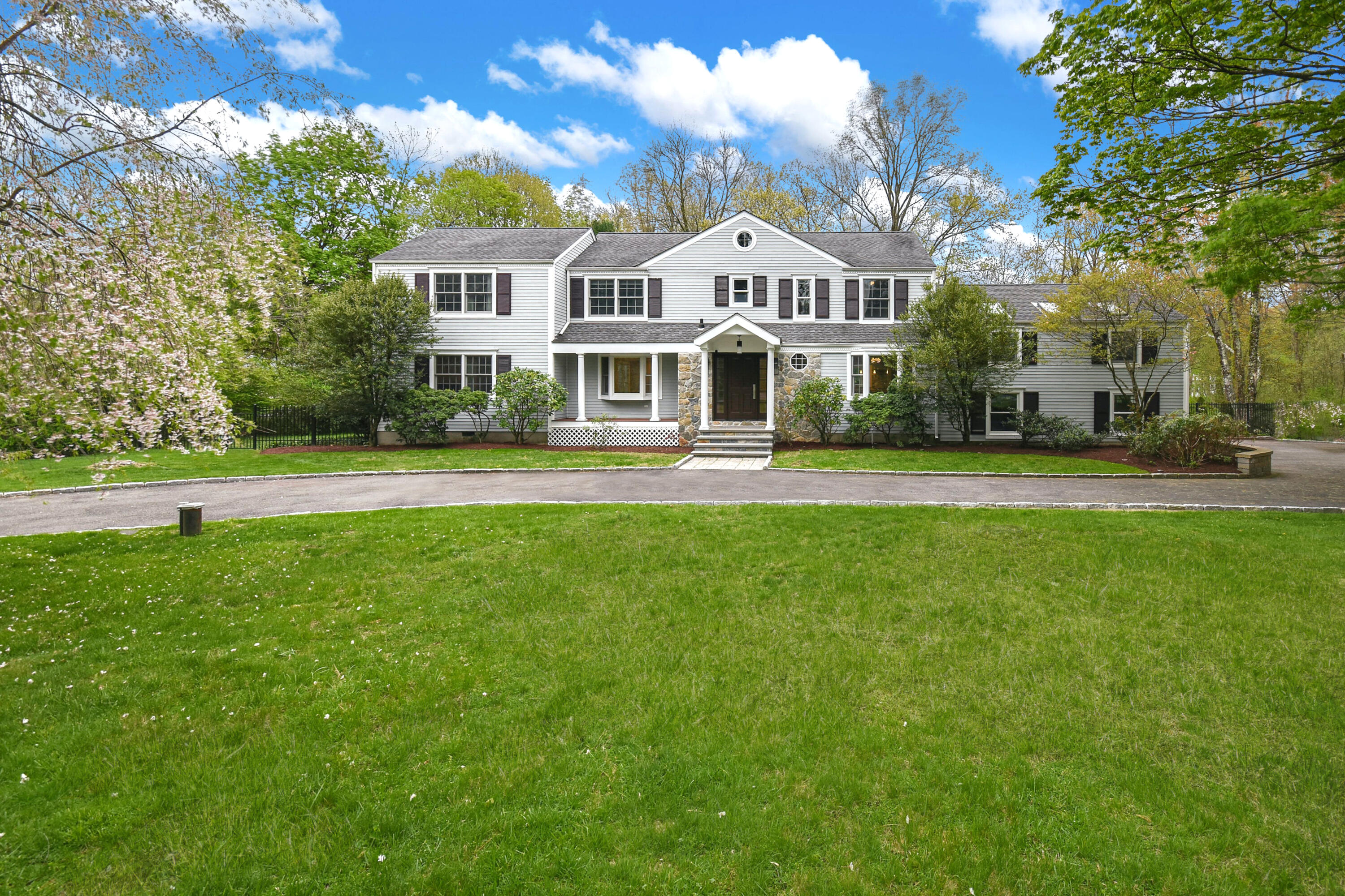 87 Juniper Road New Canaan, CT 06840 - Photo 2 of 28 a view of a house with a big yard