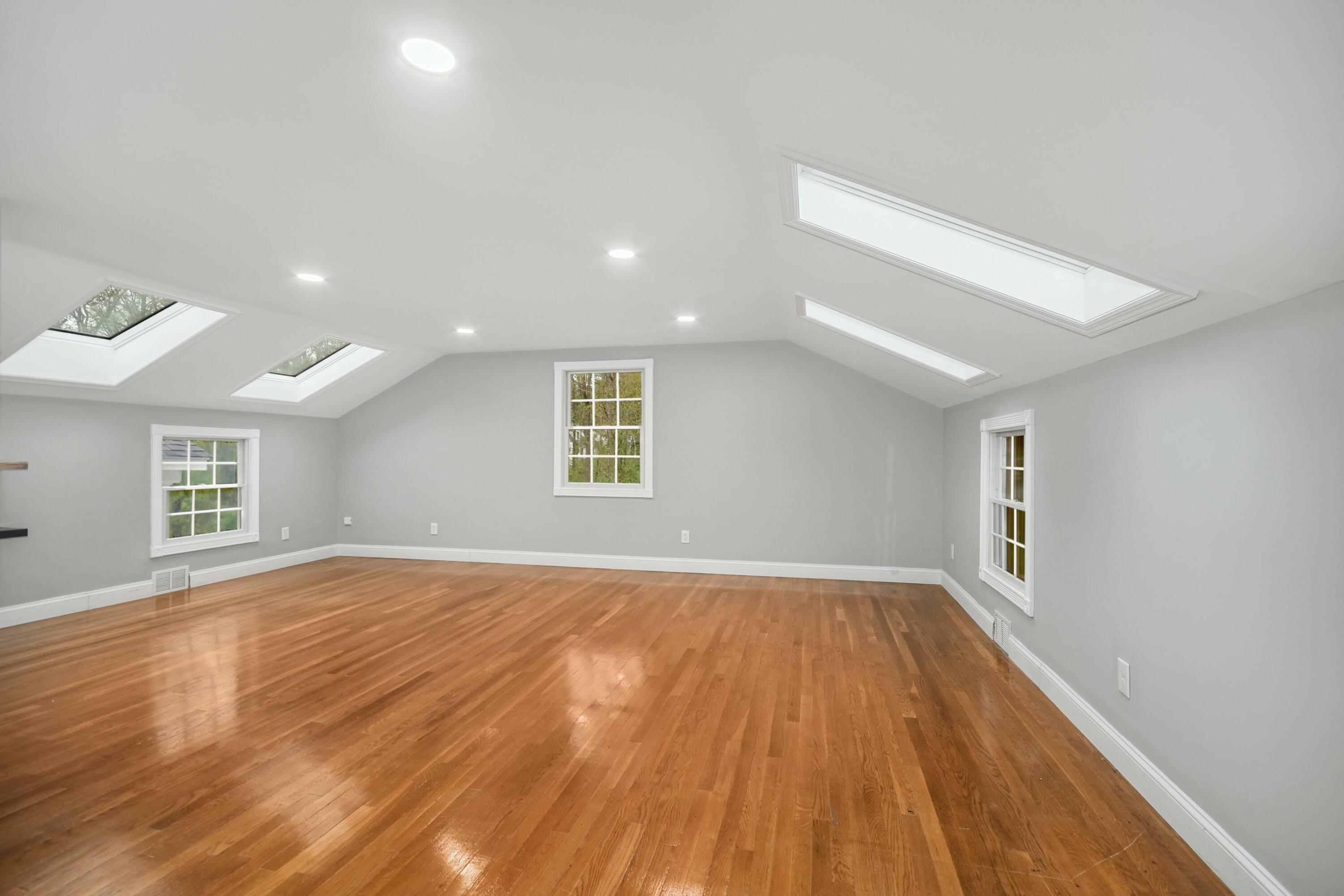 87 Juniper Road New Canaan, CT 06840 - Photo 24 of 28 an empty room with wooden floor and windows