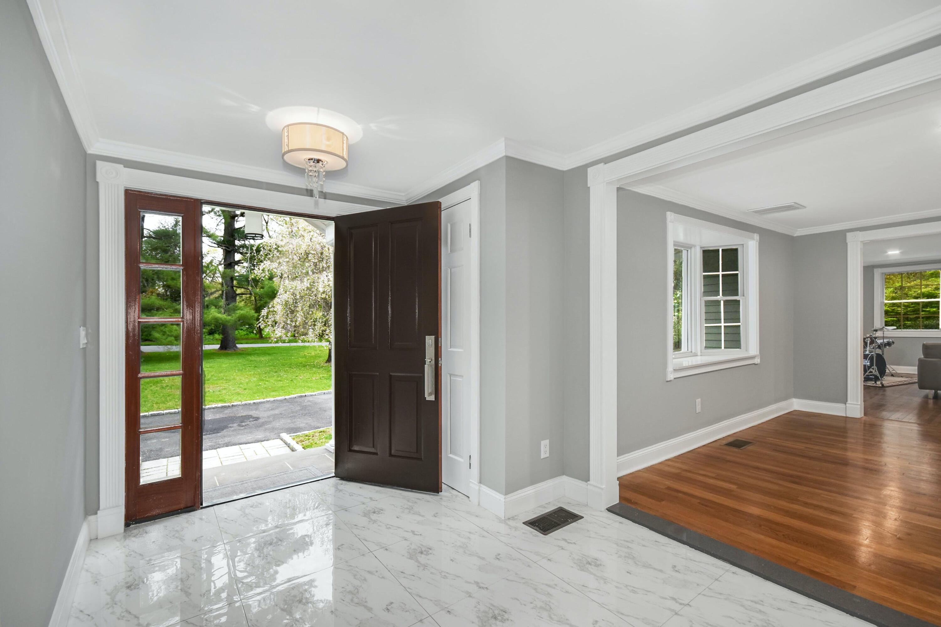 87 Juniper Road New Canaan, CT 06840 - Photo 5 of 28 a view of an empty room with wooden floor and a floor to ceiling window