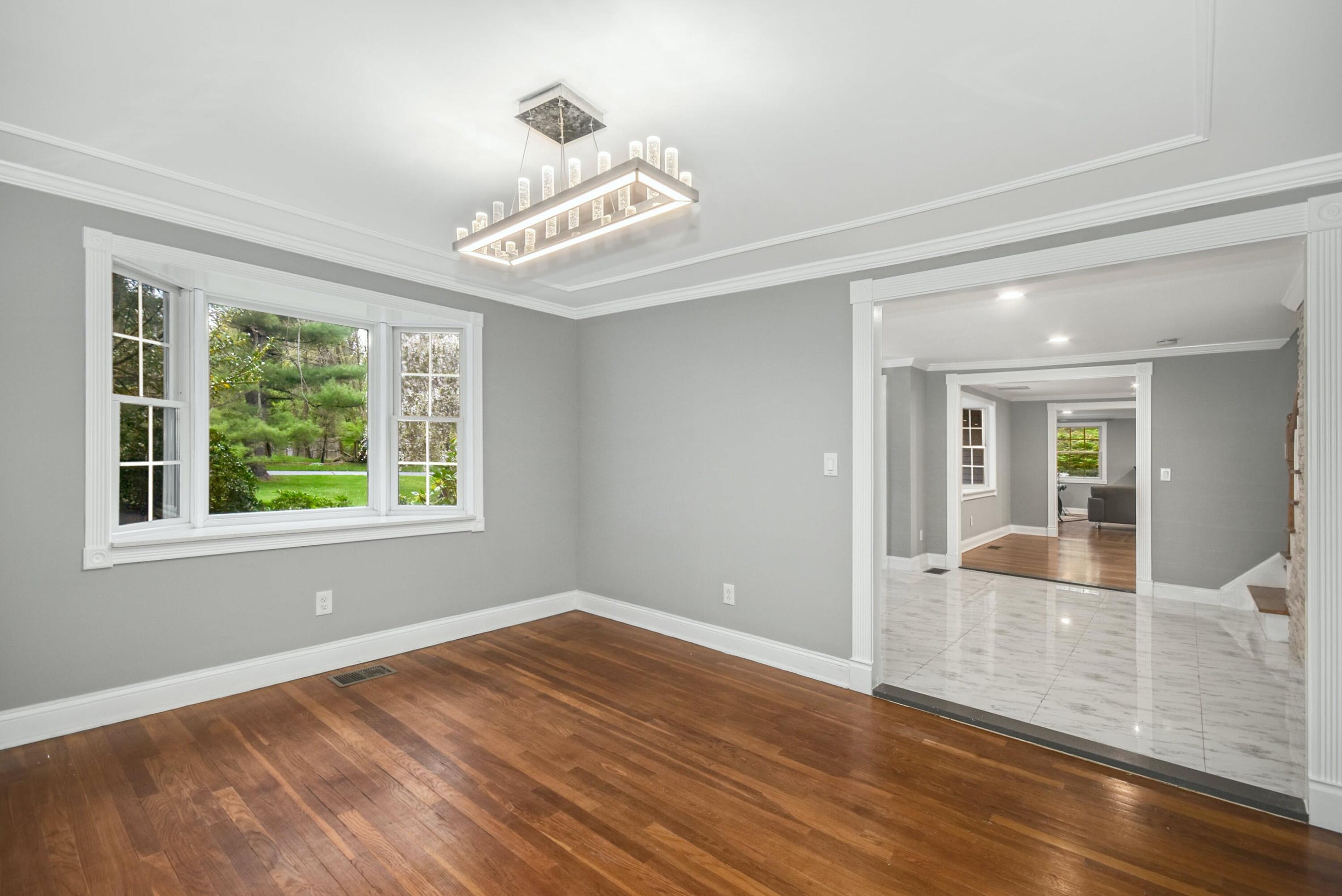 87 Juniper Road New Canaan, CT 06840 - Photo 7 of 28 a view of an empty room with wooden floor and a window