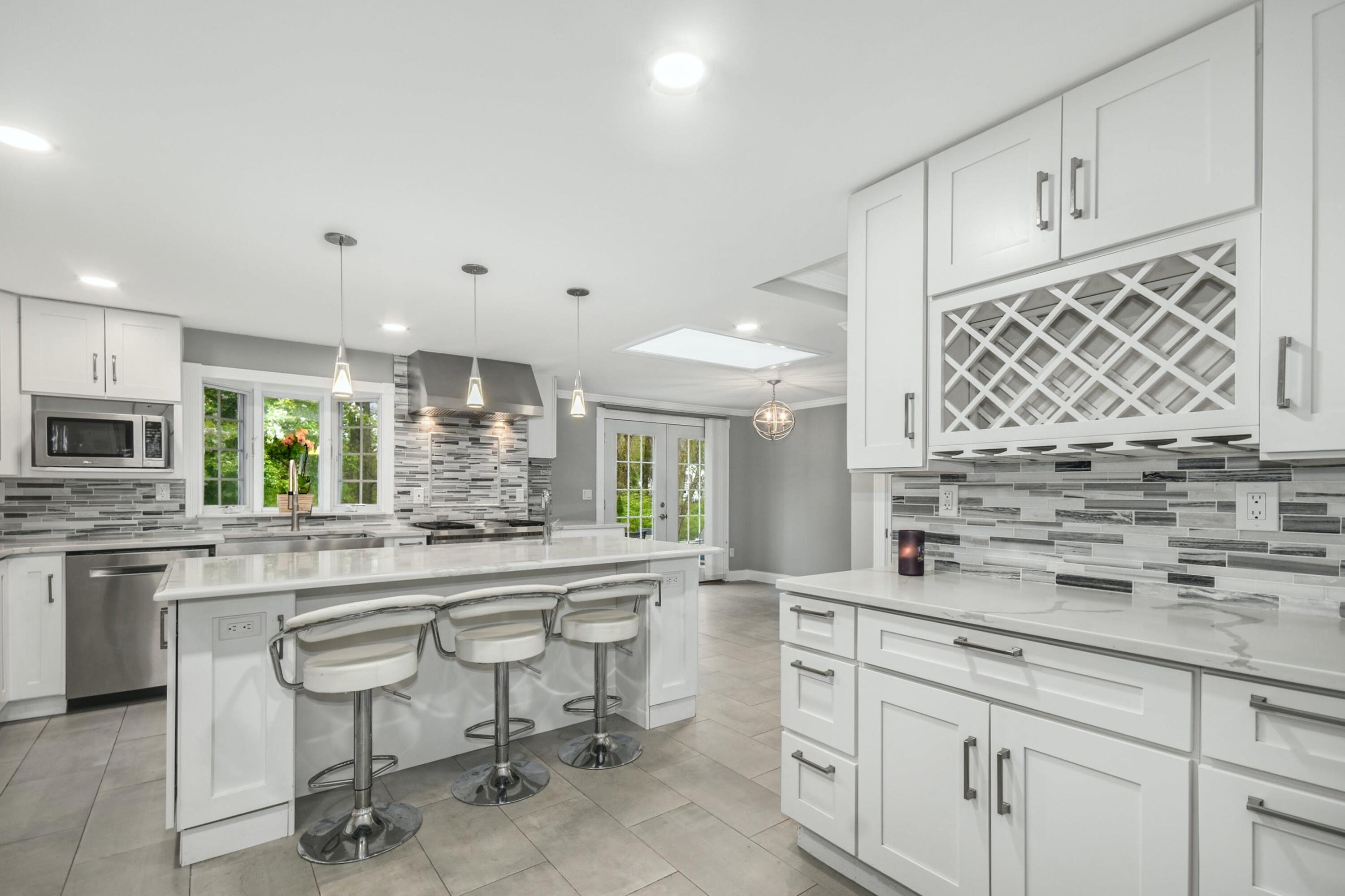 87 Juniper Road New Canaan, CT 06840 - Photo 9 of 28 a kitchen with stainless steel appliances granite countertop a sink and cabinets