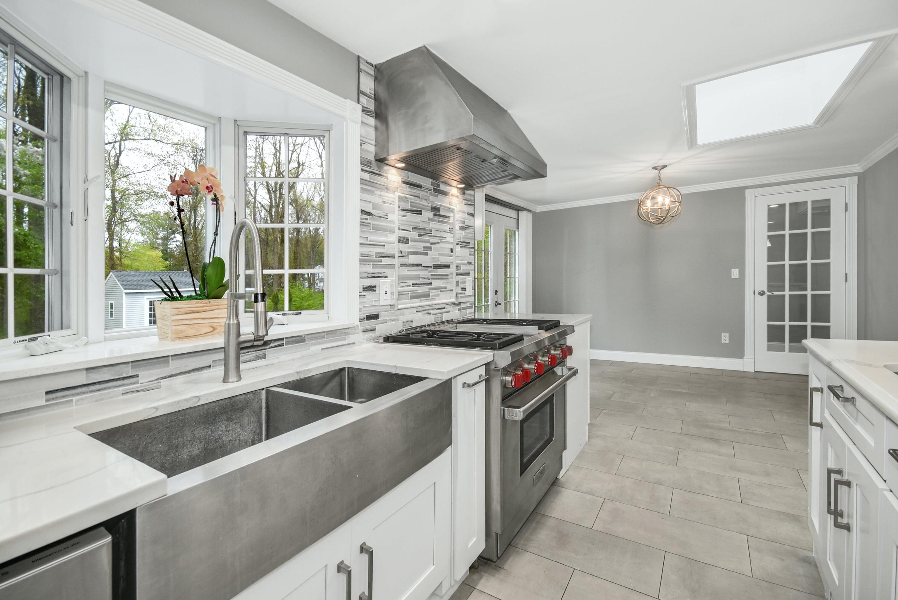 87 Juniper Road New Canaan, CT 06840 - Photo 10 of 28 a kitchen that has a sink and a stove
