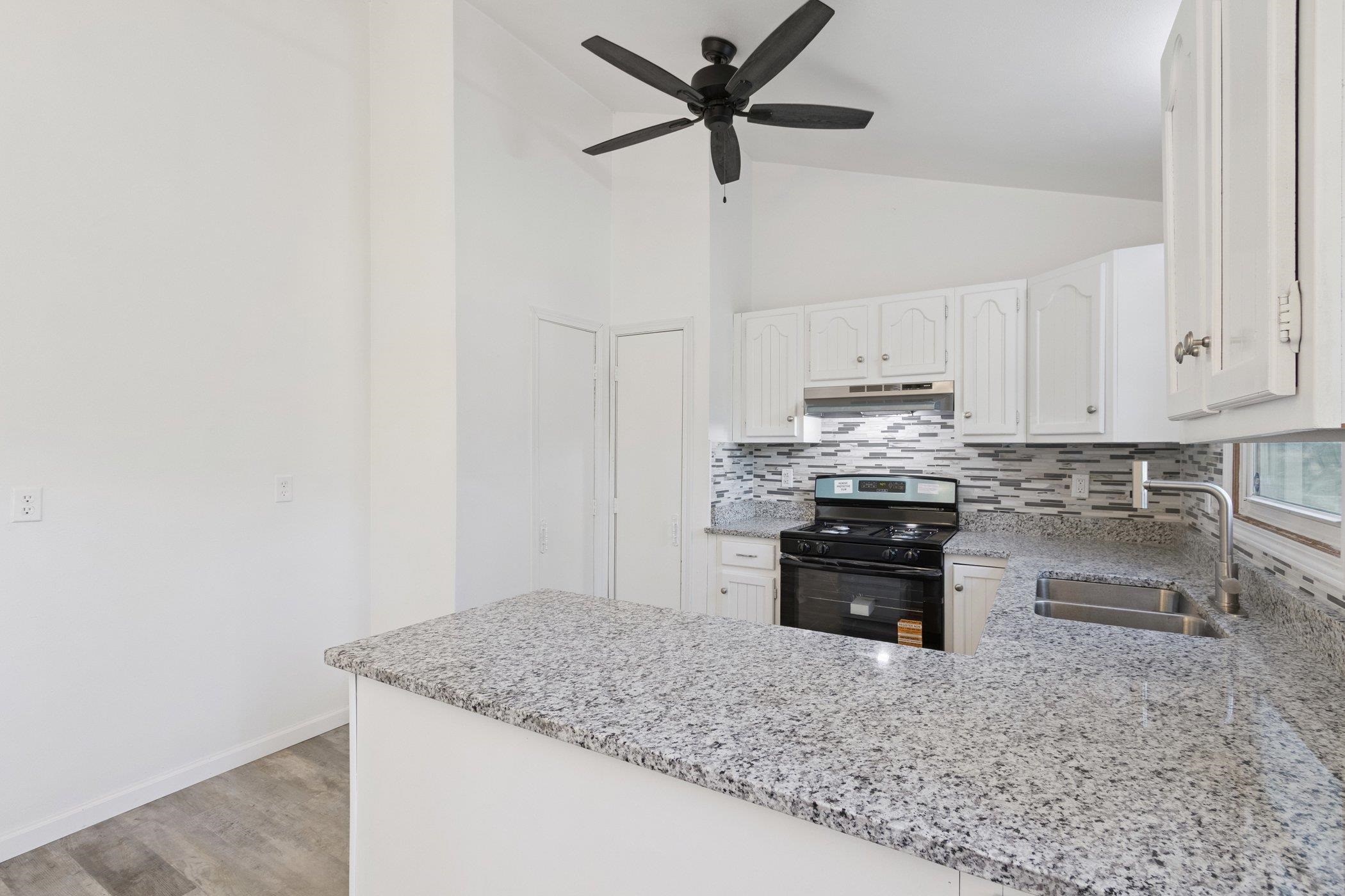 2724 Norway Pine Road Rockford, IL 61109 - Photo 11 of 49 a kitchen with stainless steel appliances granite countertop a sink stove and cabinets