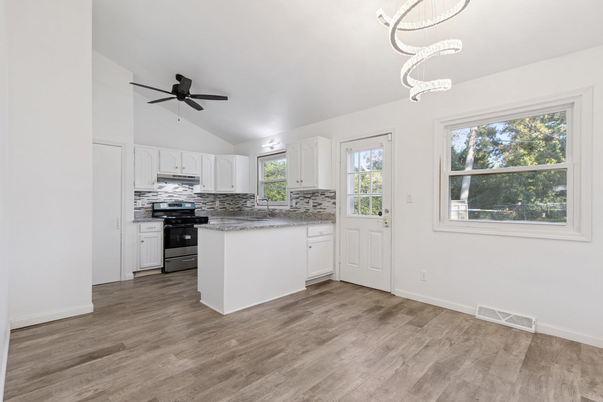 2724 Norway Pine Road Rockford, IL 61109 - Photo 18 of 49 a kitchen with kitchen island white cabinets and window