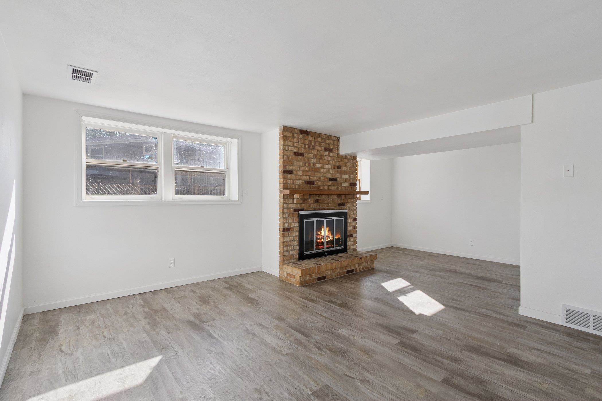 2724 Norway Pine Road Rockford, IL 61109 - Photo 19 of 49 a view of an empty room with a window and wooden floor