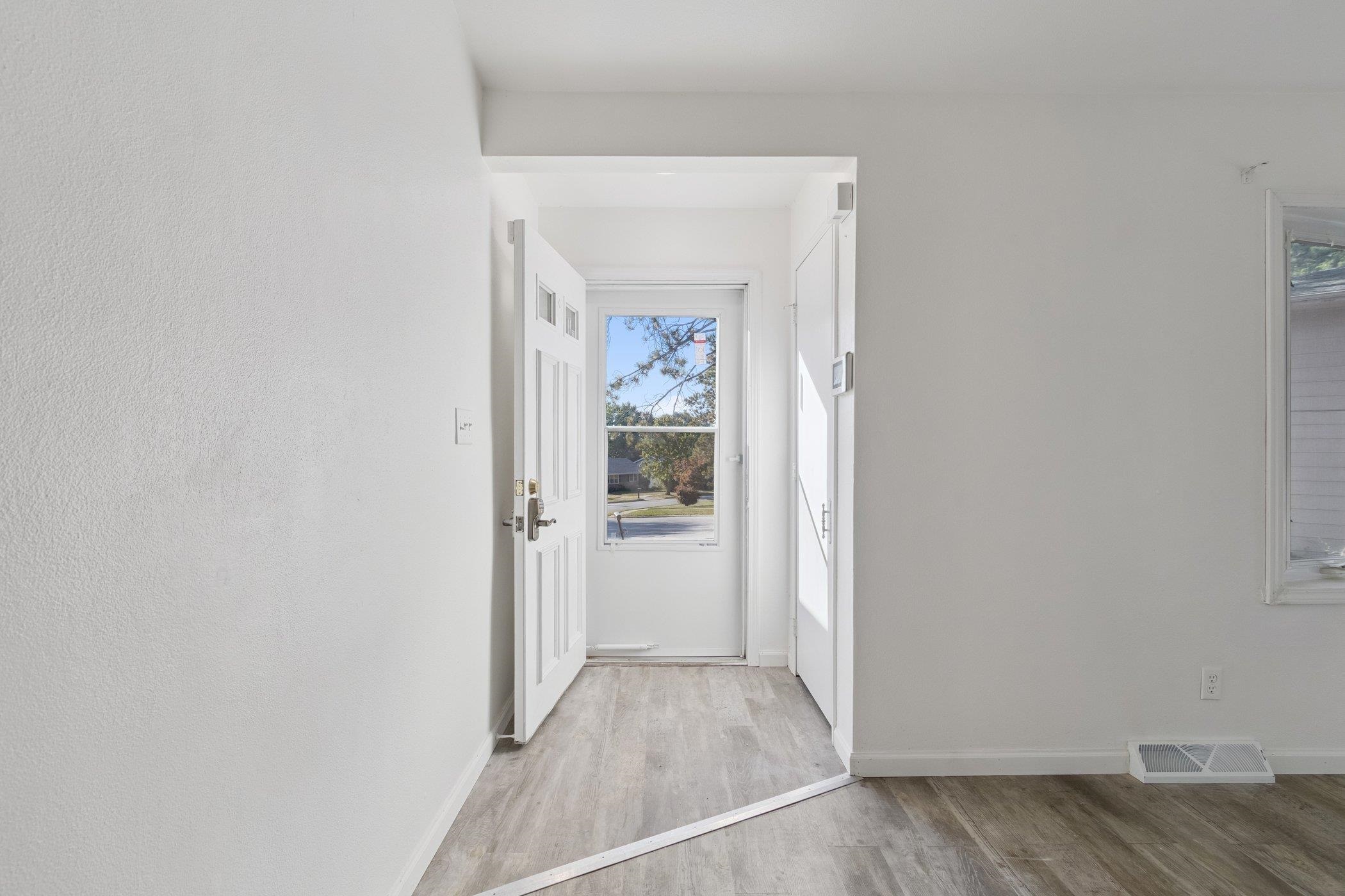 2724 Norway Pine Road Rockford, IL 61109 - Photo 27 of 49 a view of a hallway with wooden floor and a bathroom