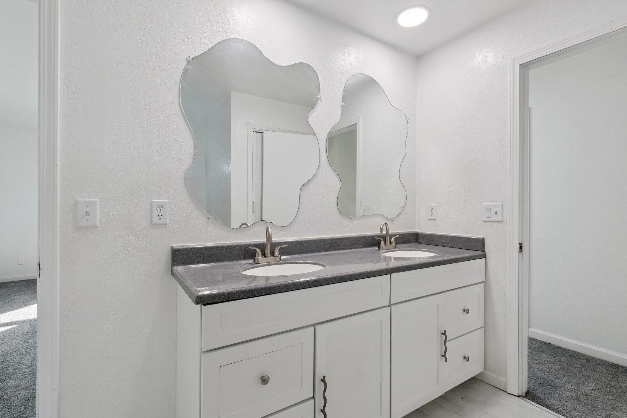 2724 Norway Pine Road Rockford, IL 61109 - Photo 36 of 49 a bathroom with a granite countertop sink and a mirror