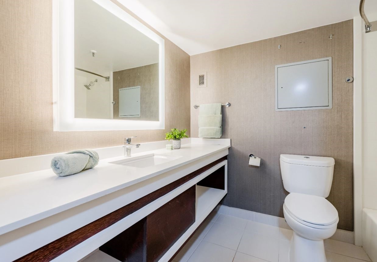 14703 Park Row Houston, TX 77079 - Photo 5 of 40 a bathroom with a granite countertop toilet sink and mirror