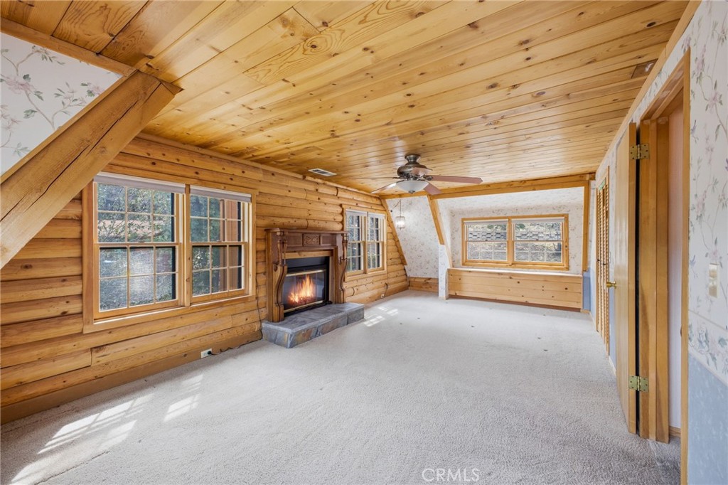 33052 Donner Lane Running Springs, CA 92382 - Photo 19 of 36 a view of an empty room with a fireplace and a window