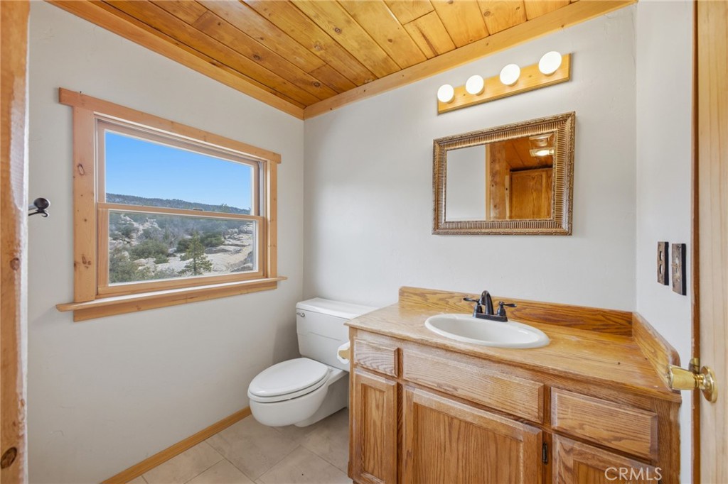 33052 Donner Lane Running Springs, CA 92382 - Photo 20 of 36 a bathroom with a toilet sink and mirror