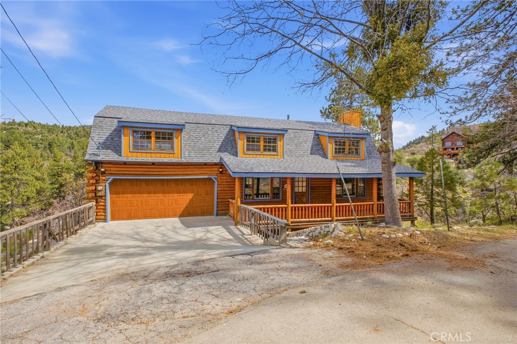 33052 Donner Lane Running Springs, CA 92382 - Photo 2 of 36 a view of a house with a yard