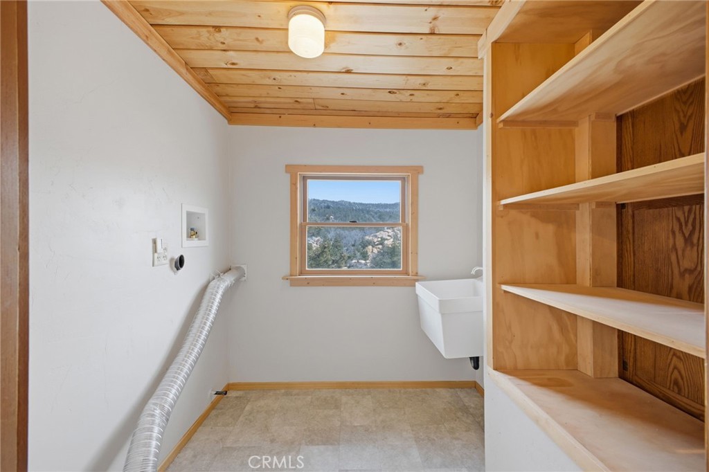 33052 Donner Lane Running Springs, CA 92382 - Photo 22 of 36 a view of hallway with washer and dryer