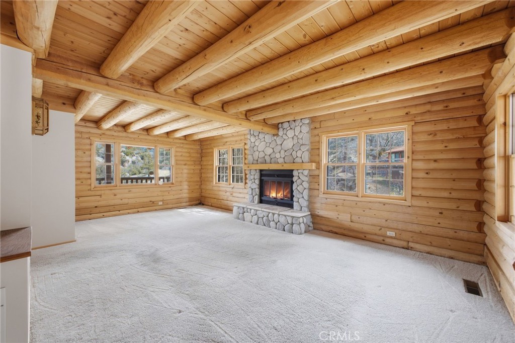 33052 Donner Lane Running Springs, CA 92382 - Photo 5 of 36 a view of an empty room with a fireplace and a window