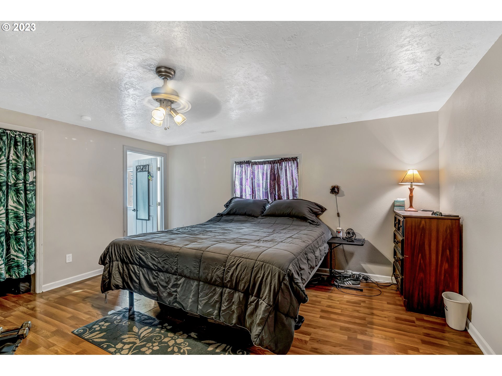 47431 Southeast Wagoneer Loop Sandy, OR 97055 - Photo 11 of 34 a bedroom with a bed with wooden floor