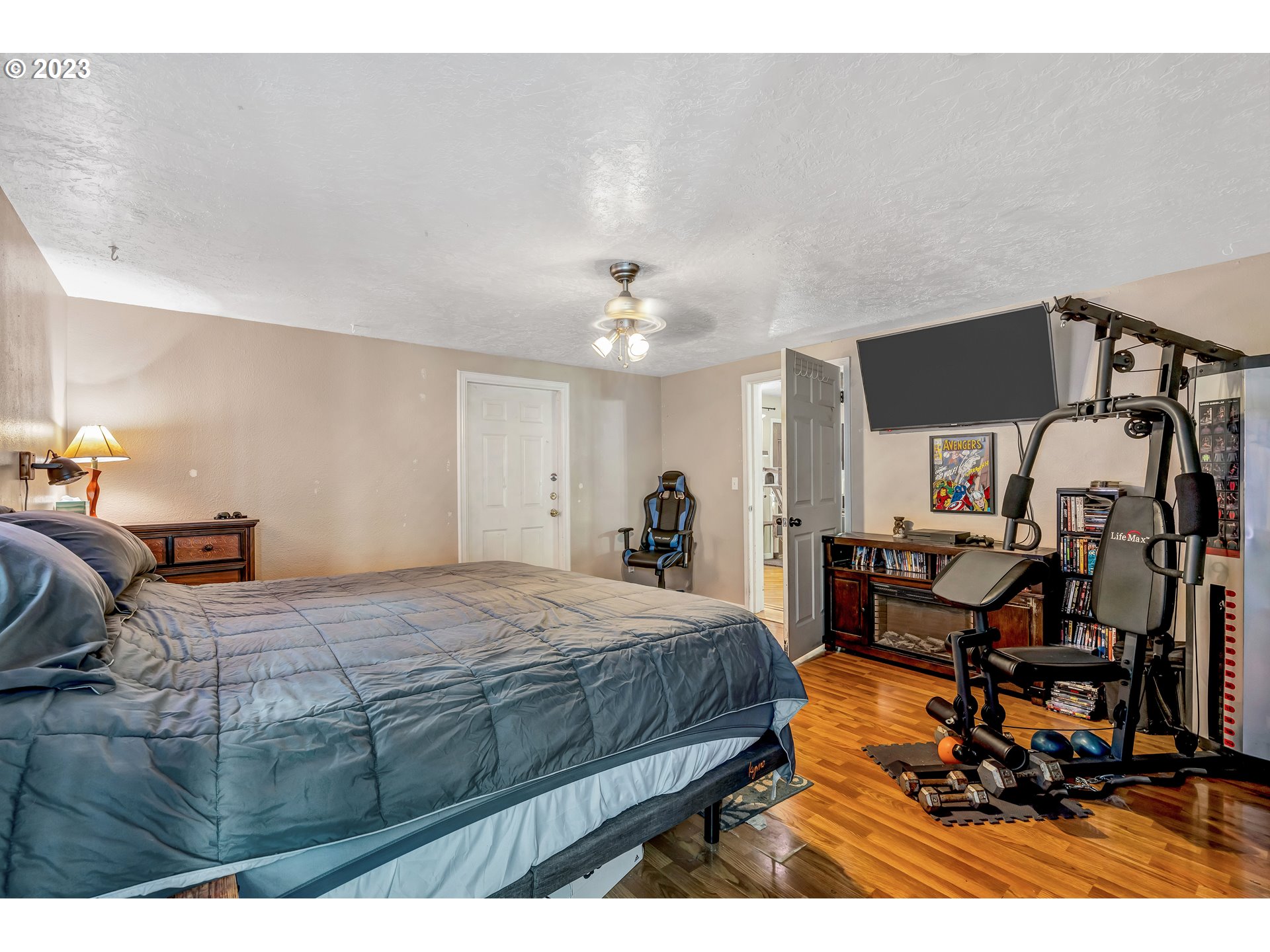 47431 Southeast Wagoneer Loop Sandy, OR 97055 - Photo 12 of 34 a bedroom with a bed and a chandelier