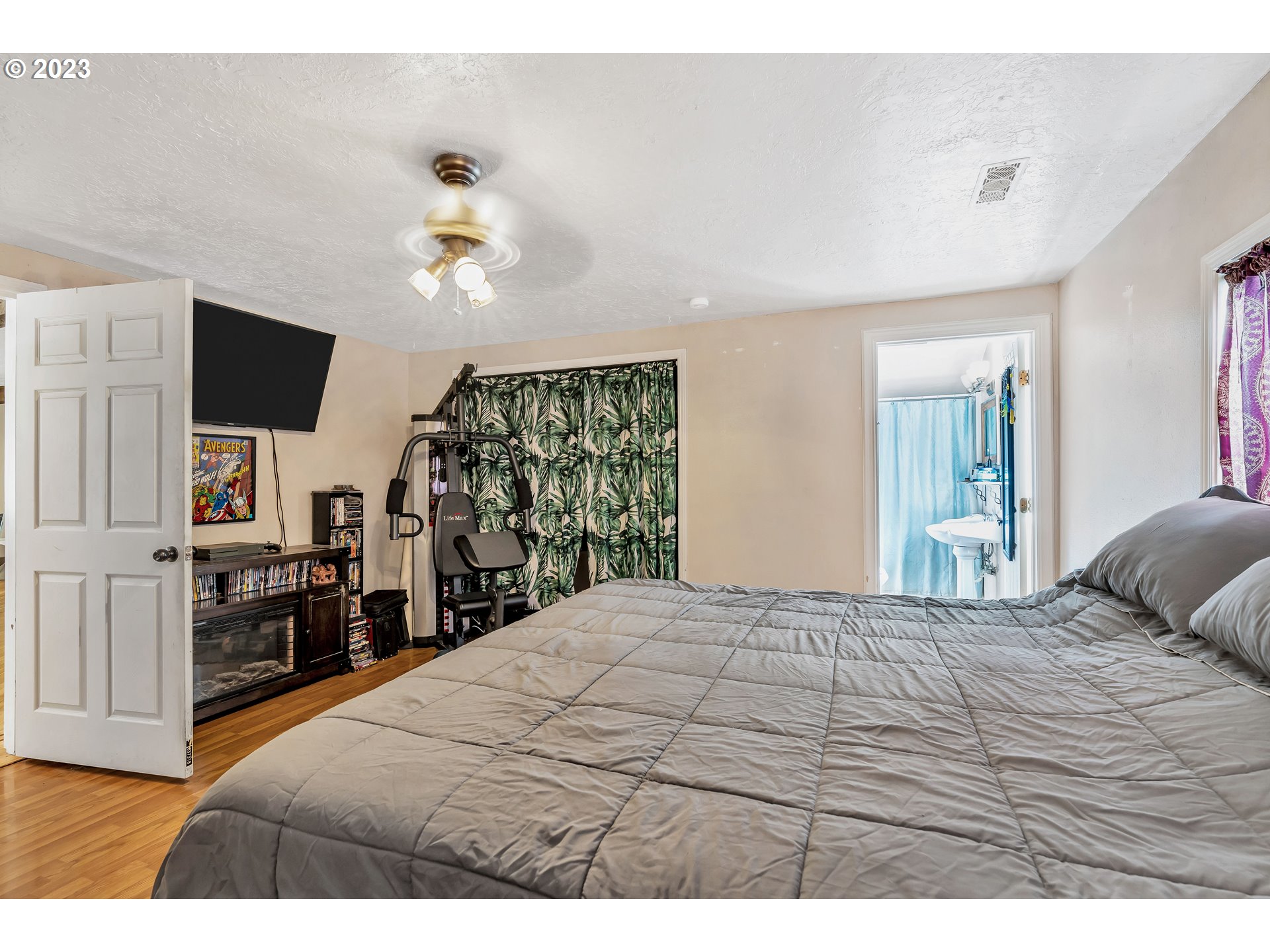 47431 Southeast Wagoneer Loop Sandy, OR 97055 - Photo 13 of 34 a bedroom with a bed and a flat tv screen on dresser