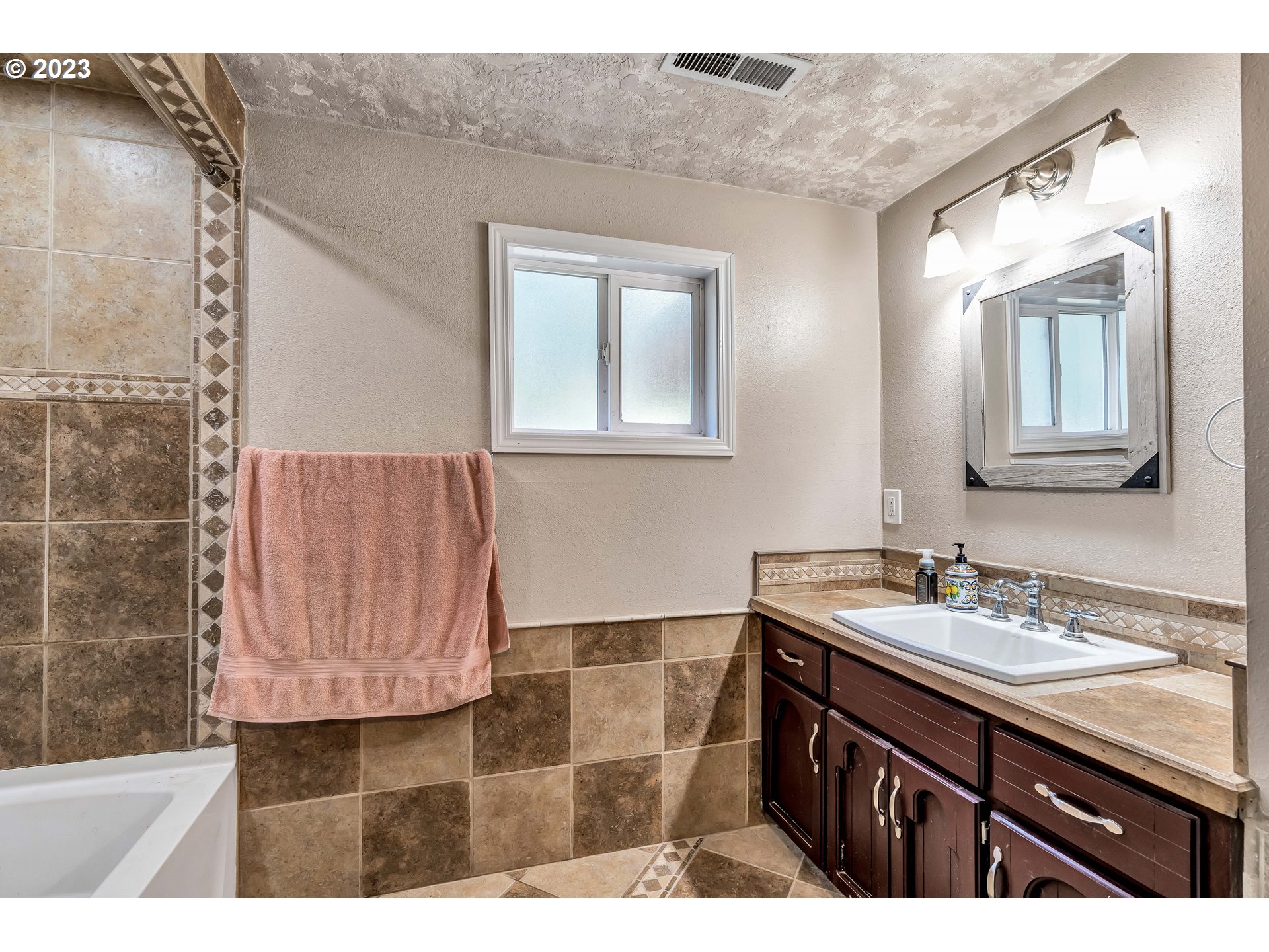 47431 Southeast Wagoneer Loop Sandy, OR 97055 - Photo 21 of 34 a bathroom with a sink vanity granite and a mirror