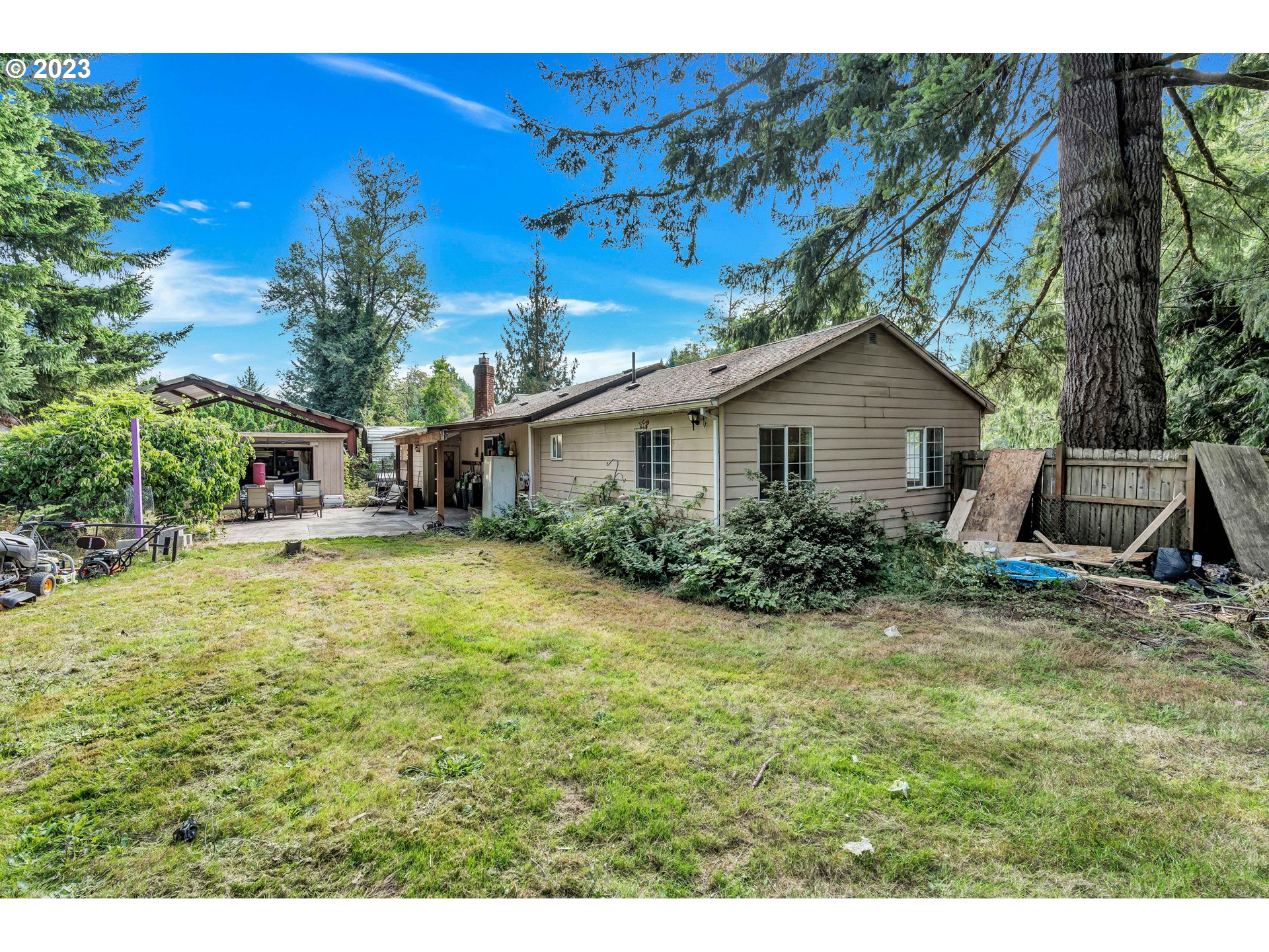 47431 Southeast Wagoneer Loop Sandy, OR 97055 - Photo 31 of 34 a view of a house with backyard and sitting area
