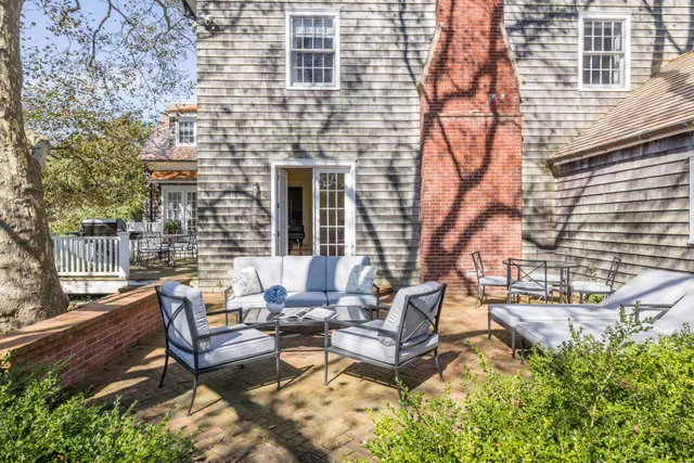 a view of a patio with furniture and a yard