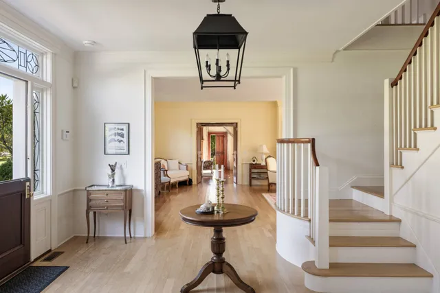 a view of hall way with furniture and floor to ceiling window