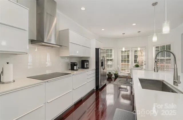 a kitchen with stainless steel appliances granite countertop sink stove and refrigerator