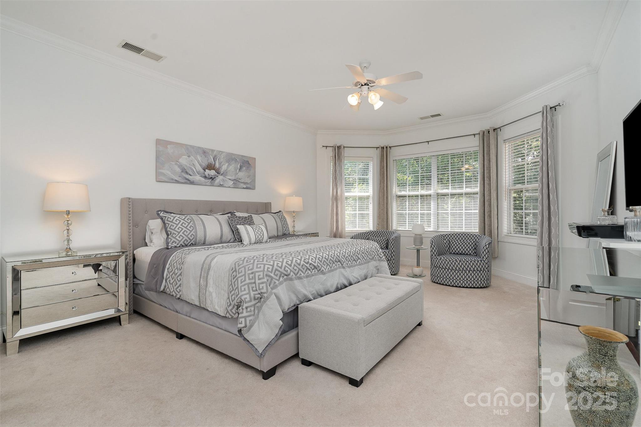 10929 Valley Spring Drive Charlotte, NC 28277 - Photo 19 of 43 a spacious bedroom with a bed and a couch