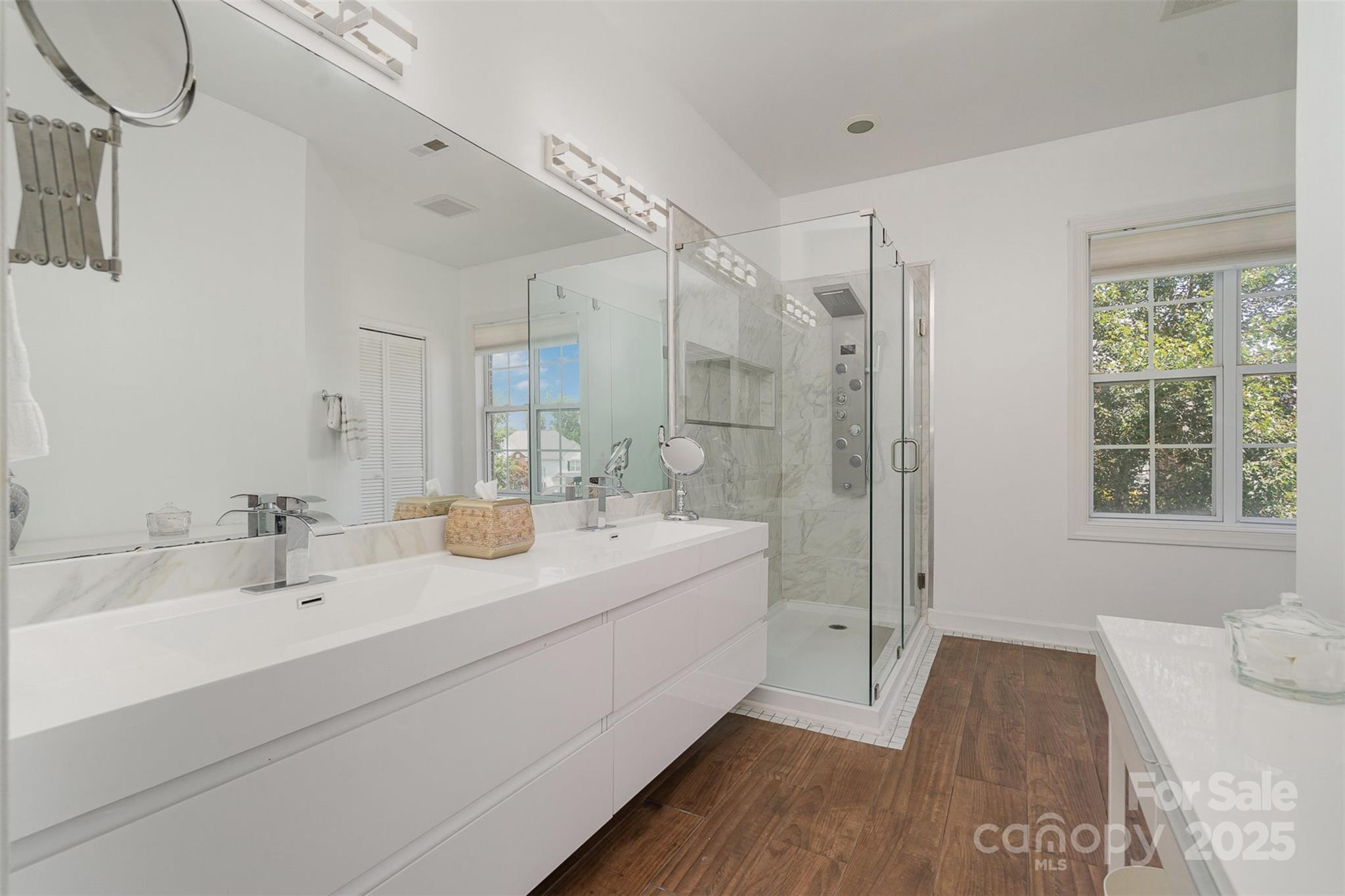 10929 Valley Spring Drive Charlotte, NC 28277 - Photo 21 of 43 a bathroom with a double vanity sink a mirror and a bathtub