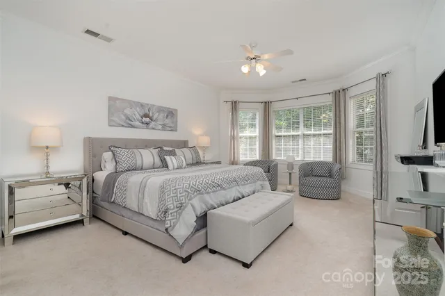 a spacious bedroom with a bed and a couch