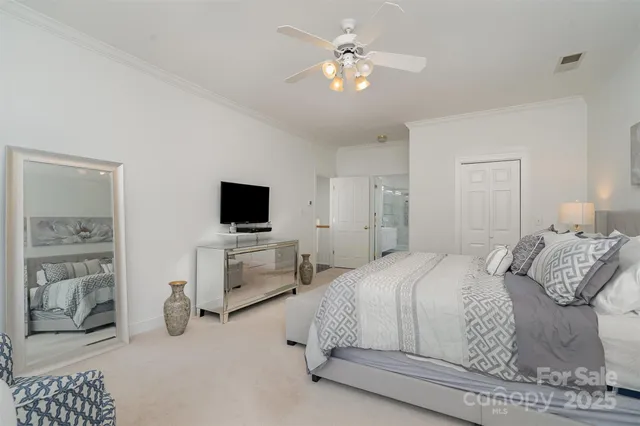 a bedroom with a bed and a television