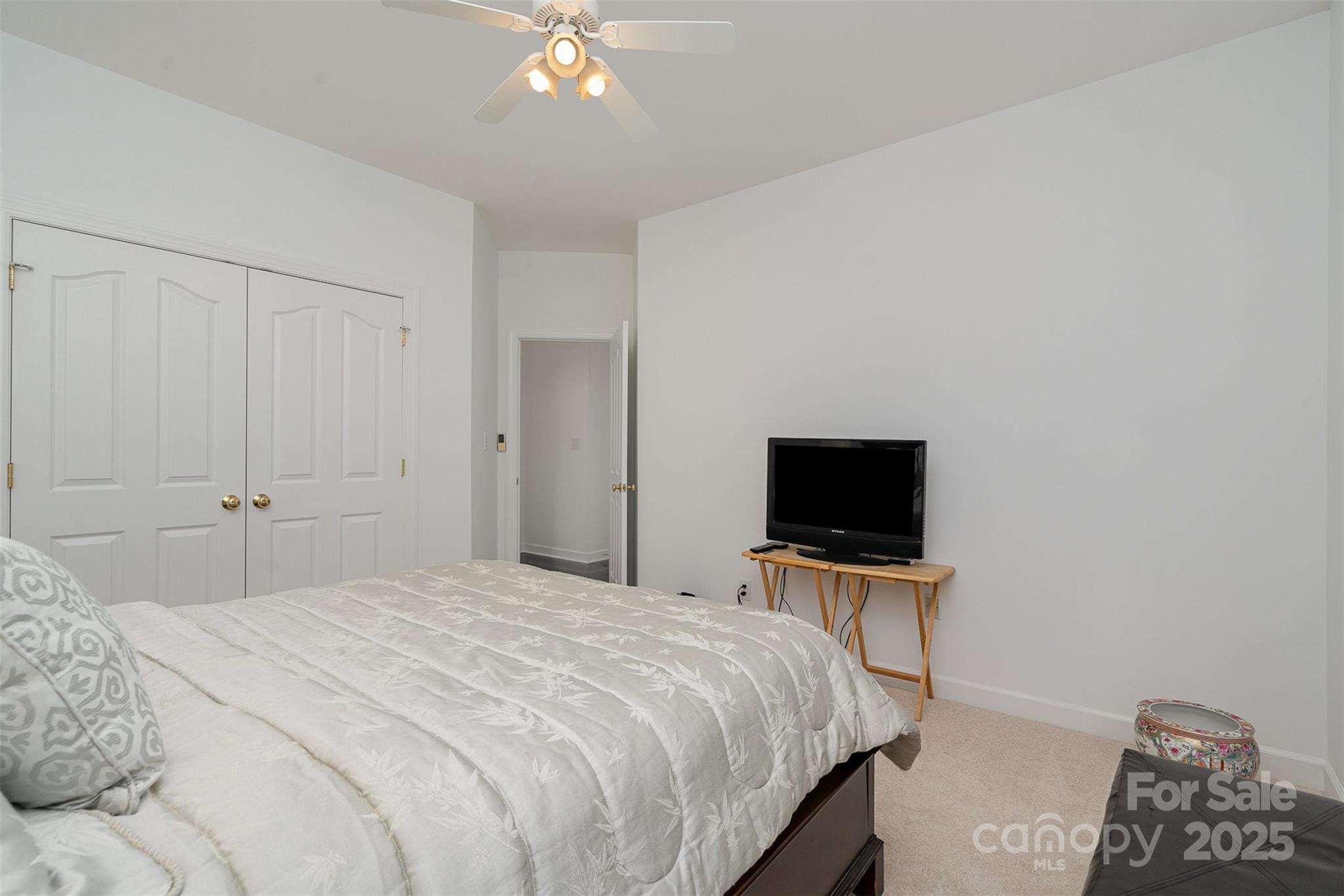 10929 Valley Spring Drive Charlotte, NC 28277 - Photo 27 of 43 a bedroom with a bed and a flat tv screen on a dresser