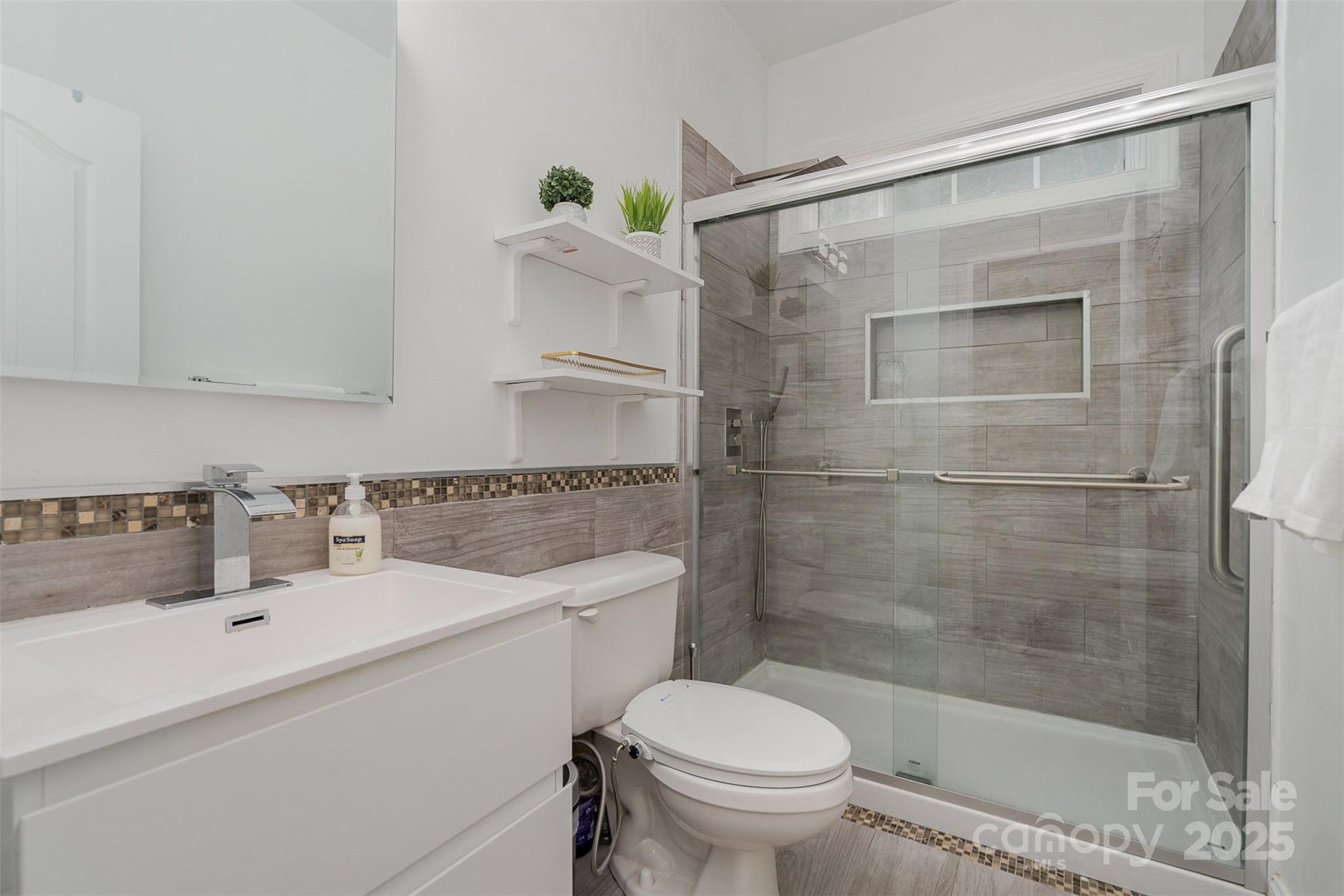10929 Valley Spring Drive Charlotte, NC 28277 - Photo 29 of 43 a bathroom with a sink toilet and shower