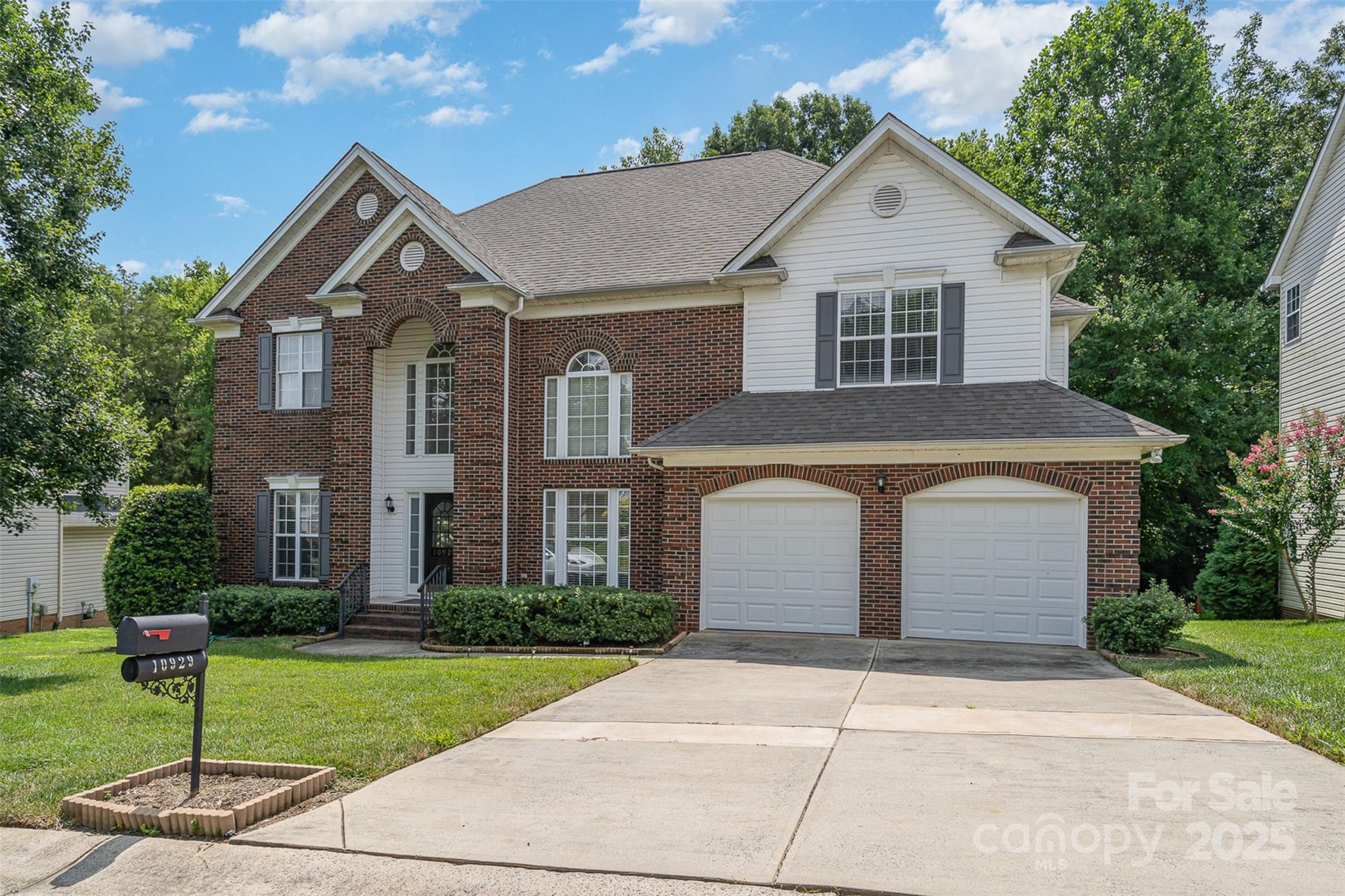 10929 Valley Spring Drive Charlotte, NC 28277 - Photo 33 of 43 a front view of a house with a yard and garage