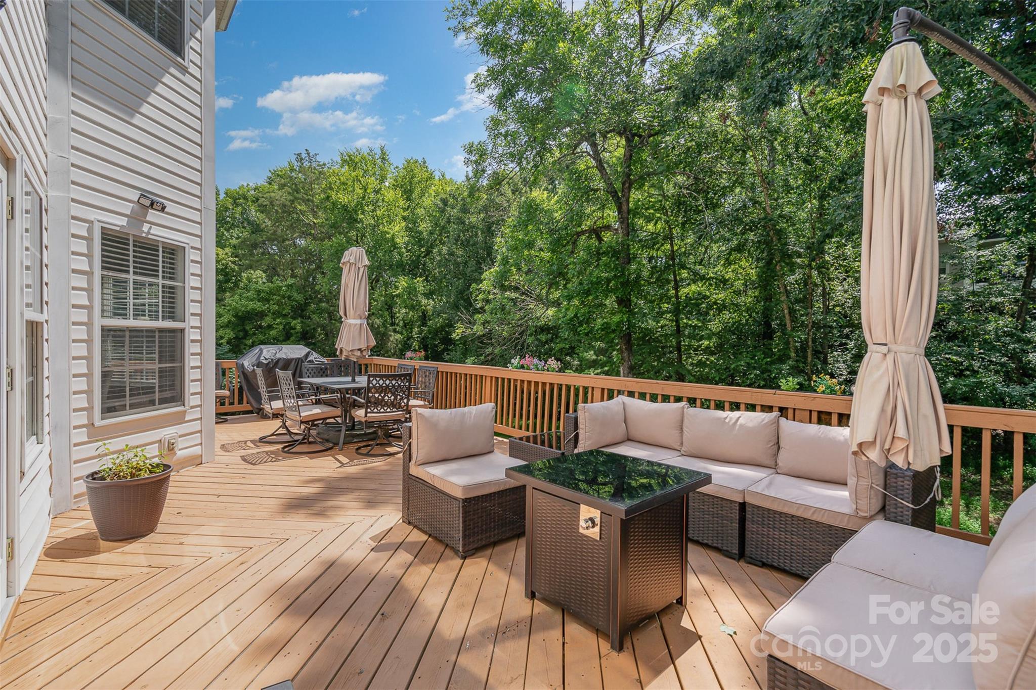 10929 Valley Spring Drive Charlotte, NC 28277 - Photo 35 of 43 a roof deck with couches and wooden fence