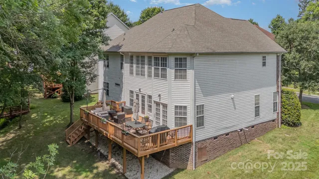 a view of a house with backyard and sitting area