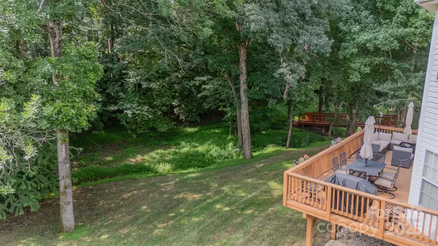 a view of a roof deck with chair and wooden floor