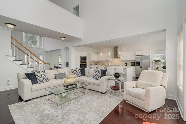 a living room with furniture white walls and a view of kitchen