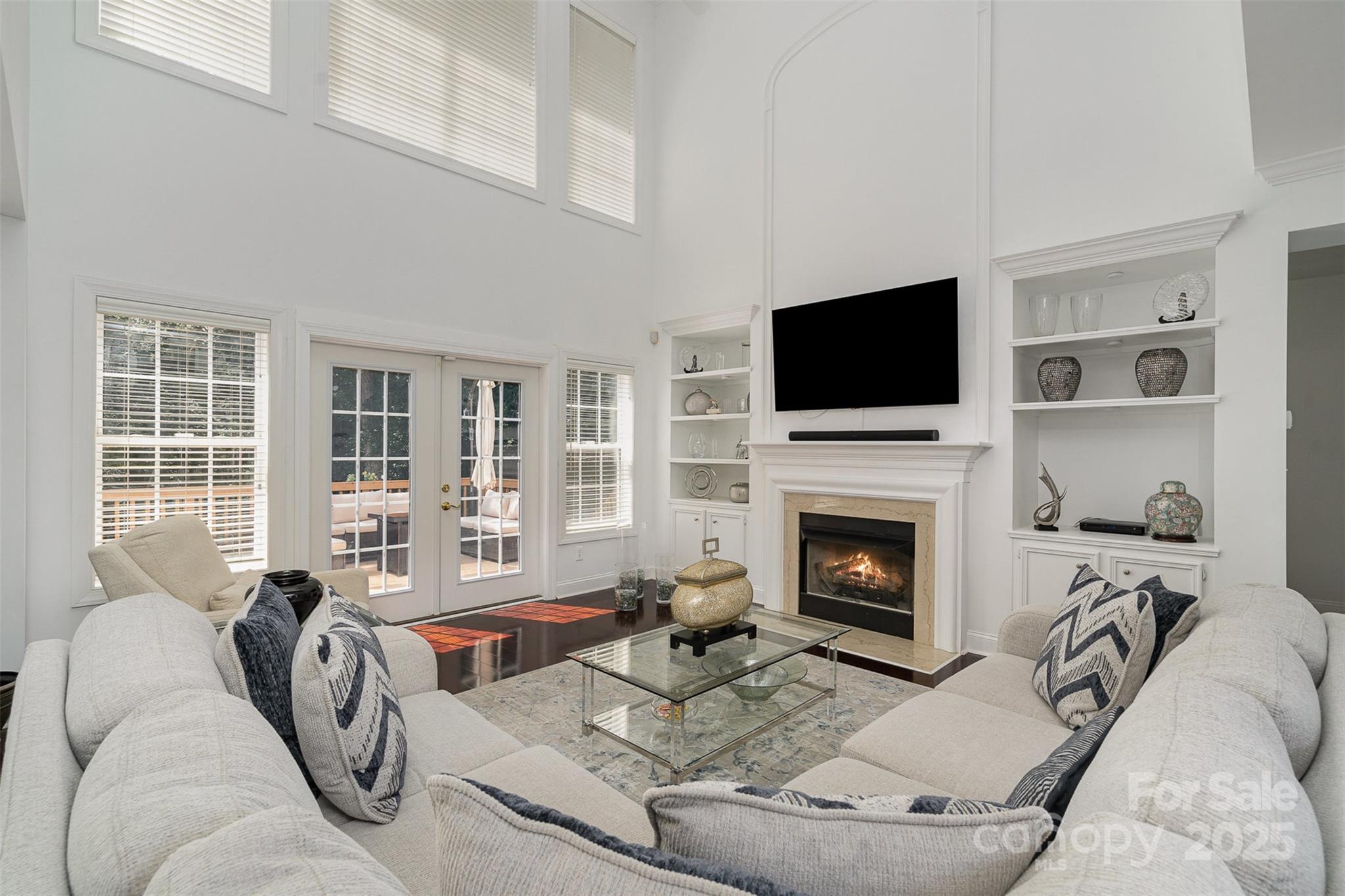 10929 Valley Spring Drive Charlotte, NC 28277 - Photo 8 of 43 a living room with furniture a fireplace and a flat screen tv