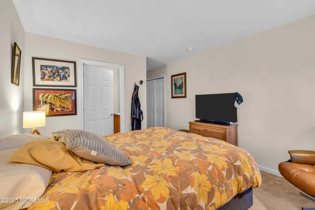 a bedroom with a bed and glass windows
