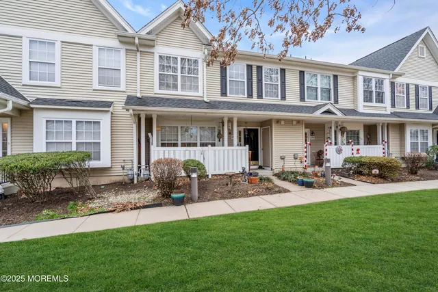 a front view of a house with patio and garden