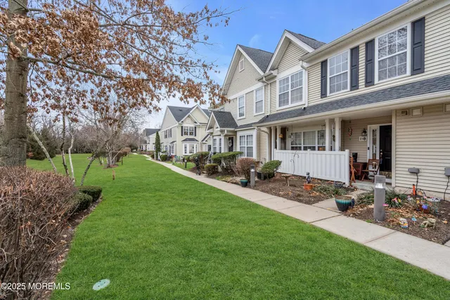 a view of a house with backyard sitting area and garden